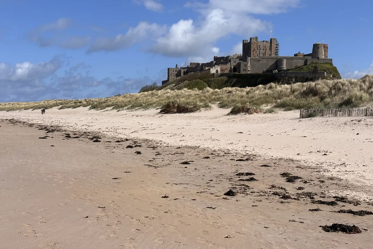 Coastal castle above a sandy Yorkshire beach on a private day tour