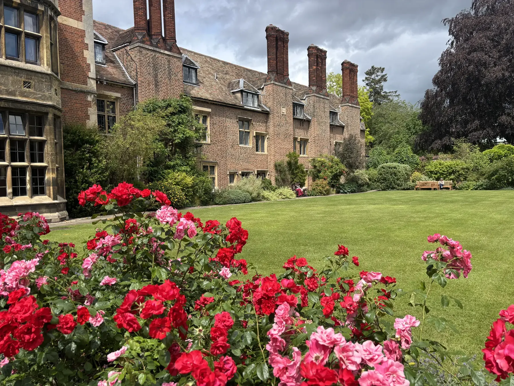 Historic architecture and manicured rose gardens at a stop on the private York to London via Cambridge scenic transfer tour